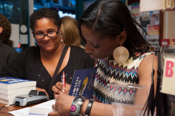 Irenosen Okojie signs a copy of Butterfly Fish for award-winning novelist Yvette Edwards